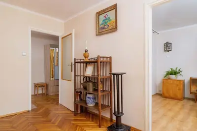 a living room with white walls and wooden floors at Nowowiejska Cosy Studio for 6 people in Cracow by Noclegi Renters in Kraków