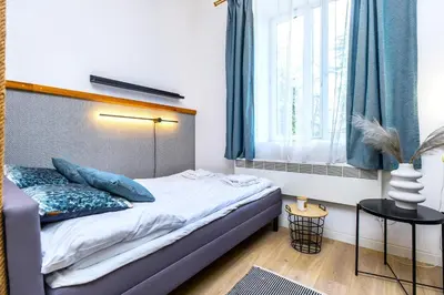 a bedroom with a bed and a window at Rently Apartments in Old Town in Kraków