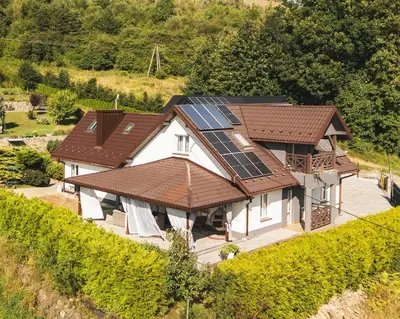 an aerial view of a house with solar panels on it at Dom w Chomranicach- Jacuzzi, domek grillowy in Chomranice