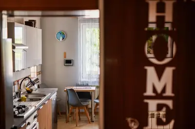 a kitchen with a table and chairs and a table and a kitchen with a table at Dom w Chomranicach- Jacuzzi, domek grillowy in Chomranice