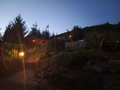 a street light in front of a house at night at Dom w Chomranicach- Jacuzzi, domek grillowy in Chomranice