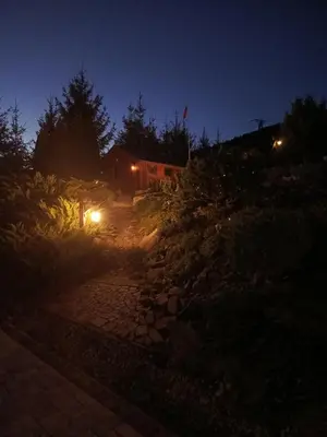 a night time view of a stone path with lights at Dom w Chomranicach- Jacuzzi, domek grillowy in Chomranice
