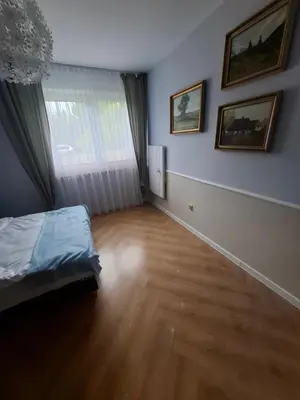 an empty room with a bed and a window at Apartamenty TUTERRA I in Zabagnie