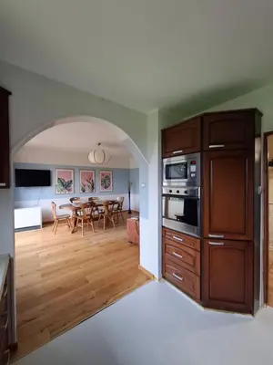 an open kitchen and dining room with a table at Apartamenty TUTERRA I in Zabagnie