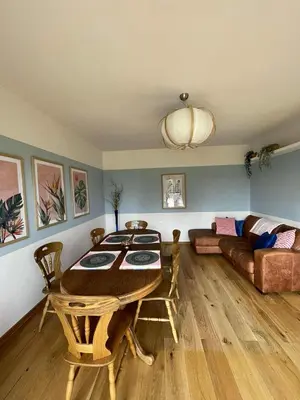 a living room with a table and a couch at Apartamenty TUTERRA I in Zabagnie