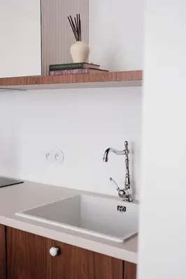 a white sink in a kitchen with a mirror at Vintage Soul Kazimierz Old Town in Kraków
