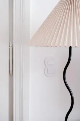 a white lamp sitting next to a door at Vintage Soul Kazimierz Old Town in Kraków