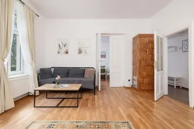 a living room with a couch and a table at Dietla Family Apartment in Kraków City Center by Noclegi Renters in Kraków