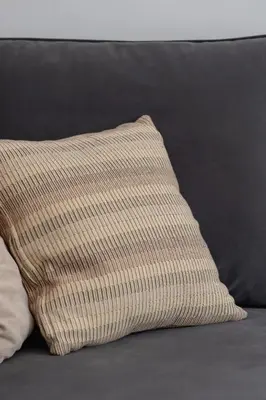a brown and white pillow on a couch at Dietla Family Apartment in Kraków City Center by Noclegi Renters in Kraków