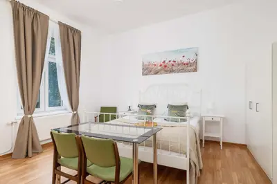 a white bedroom with a glass table and chairs at Dietla Family Apartment in Kraków City Center by Noclegi Renters in Kraków