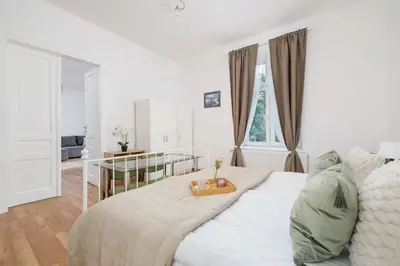 a bedroom with a white bed with a tray on it at Dietla Family Apartment in Kraków City Center by Noclegi Renters in Kraków