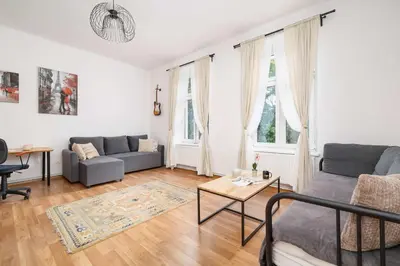 a living room with a couch and a table at Dietla Family Apartment in Kraków City Center by Noclegi Renters in Kraków