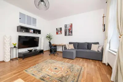 a living room with a couch and a table at Dietla Family Apartment in Kraków City Center by Noclegi Renters in Kraków