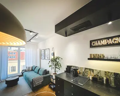 a living room with a blue couch in a room at Bakelit Studio - Design hideaway - Calm, quality & location in Kraków
