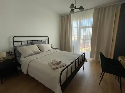 a bedroom with a large bed and a window at Apartament Oboźna in Kraków