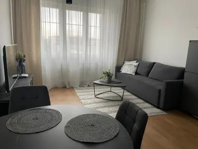 a living room with a couch and a table at Apartament Oboźna in Kraków