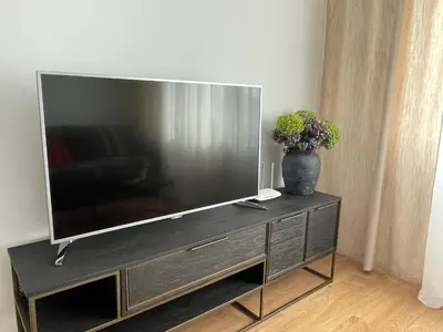 a large flat screen tv sitting on a entertainment center at Apartament Oboźna in Kraków