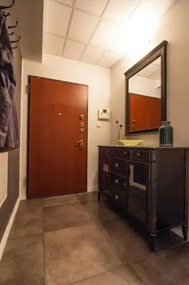 a bathroom with a vanity and a mirror and a door at Large Krakow Apartment - Near Kazimierz - City Center in Kraków