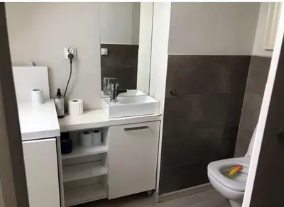 a white bathroom with a sink and a toilet at Large Krakow Apartment - Near Kazimierz - City Center in Kraków