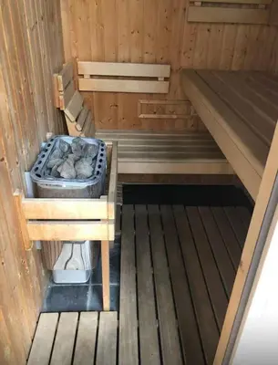 an inside view of a sauna with a bench in it at Large Krakow Apartment - Near Kazimierz - City Center in Kraków