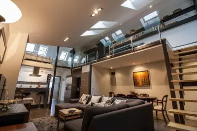 a living room with a couch and a loft at Large Krakow Apartment - Near Kazimierz - City Center in Kraków