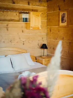 a bedroom with a bed and a lamp on a table at Apartamenty Przystań 18 Gorce w Rabce Zdrój in Rabka