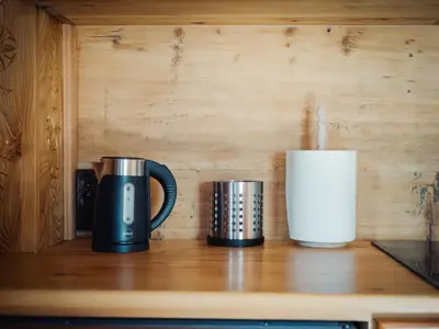 two coffee cups sitting on a counter next to a candle at Apartamenty Przystań 18 Gorce w Rabce Zdrój in Rabka