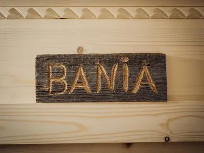 a sign that says bank on a wooden wall at Apartamenty Przystań 18 Gorce w Rabce Zdrój in Rabka