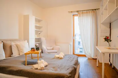 a bedroom with a bed with two stuffed animals on it at Rakowicka Residence Parking Balkon By Hosty in Kraków