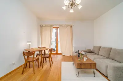 a living room with a couch and a table at Rakowicka Residence Parking Balkon By Hosty in Kraków