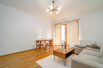 a living room with a couch and a table at Rakowicka Residence Parking Balkon By Hosty in Kraków