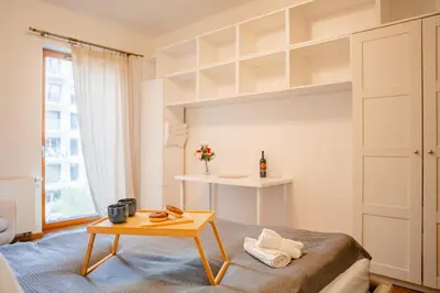 a bedroom with a bed and a table at Rakowicka Residence Parking Balkon By Hosty in Kraków