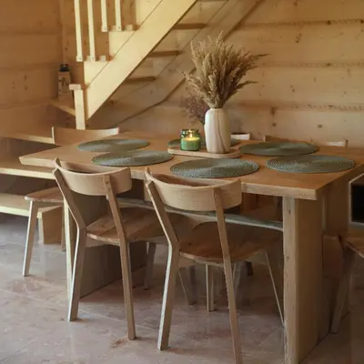 a wooden table and chairs in a room at Leśny Zakątek Zawoja in Stryszawa