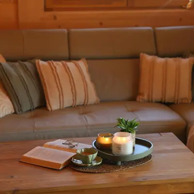 a coffee table with candles on top of a couch at Leśny Zakątek Zawoja in Stryszawa