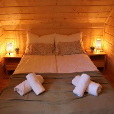 a bedroom with a bed with two pillows on it at Leśny Zakątek Zawoja in Stryszawa