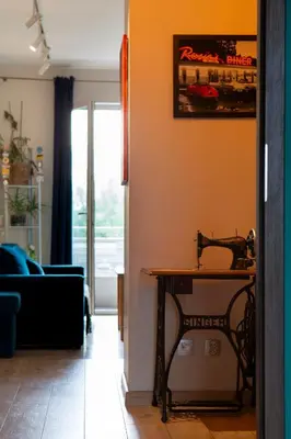 a living room with a table with a sewing machine at Walerego Sławka Apartament in Kraków