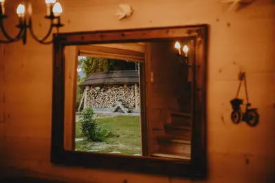 a mirror hanging on a wall with a window at Góralski dom balia kominek Lawendowy Dom na Wichrowym Wzgórzu in Łętownia Dolna
