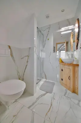 a white bathroom with a toilet and a sink at Góralski dom balia kominek Lawendowy Dom na Wichrowym Wzgórzu in Łętownia Dolna