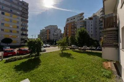 a grassy area in a city with buildings at Osiedle Piastów Charming Apartment by BookingHost in Kraków