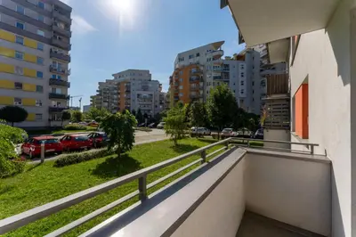 a balcony of a building with a view of a street at Osiedle Piastów Charming Apartment by BookingHost in Kraków