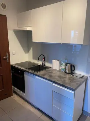 a kitchen with a sink and a stove at Apart Wielicka 57 in Kraków