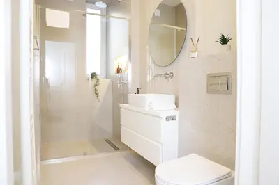 a black and white refrigerator with a tennis ball on the floor at Nowy Kleparz 102 m2 with 3 Separate Bedrooms in Kraków