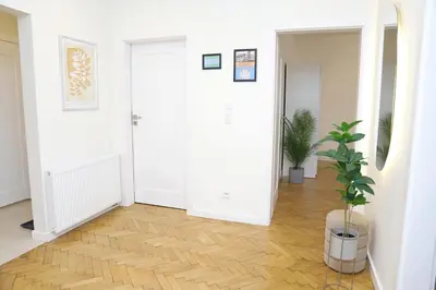 a living room with a white couch and a television at Nowy Kleparz 102 m2 with 3 Separate Bedrooms in Kraków
