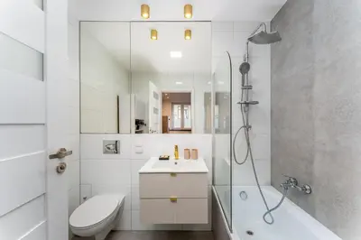 a bathroom with a shower toilet and a sink at Rakowicka Superior Studio by BookingHost in Kraków