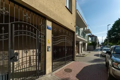 a building with a gate on the side of a street at Rakowicka Superior Studio by BookingHost in Kraków