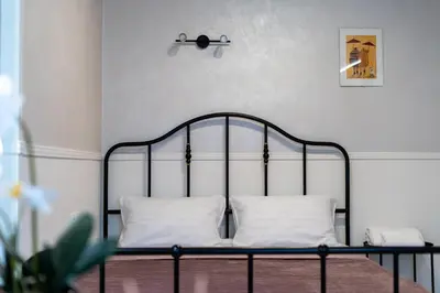a metal bed with two pillows on it in a room at Rakowicka Superior Studio by BookingHost in Kraków