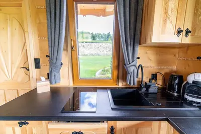 a kitchen with a sink and a window at Babi czas in Podsarnie