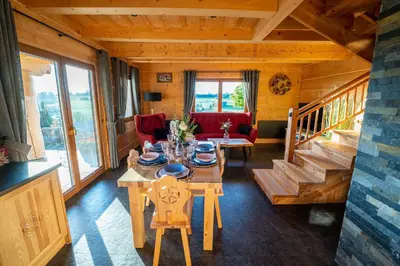 a dining room with a table and chairs in a cabin at Babi czas in Podsarnie