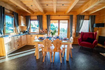 a kitchen with a table and chairs in a room at Babi czas in Podsarnie
