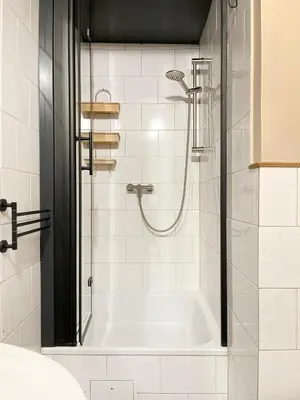 a bathroom with a shower with a white tub at Cozy Apartment Inspiro, Cracow Old Town in Kraków